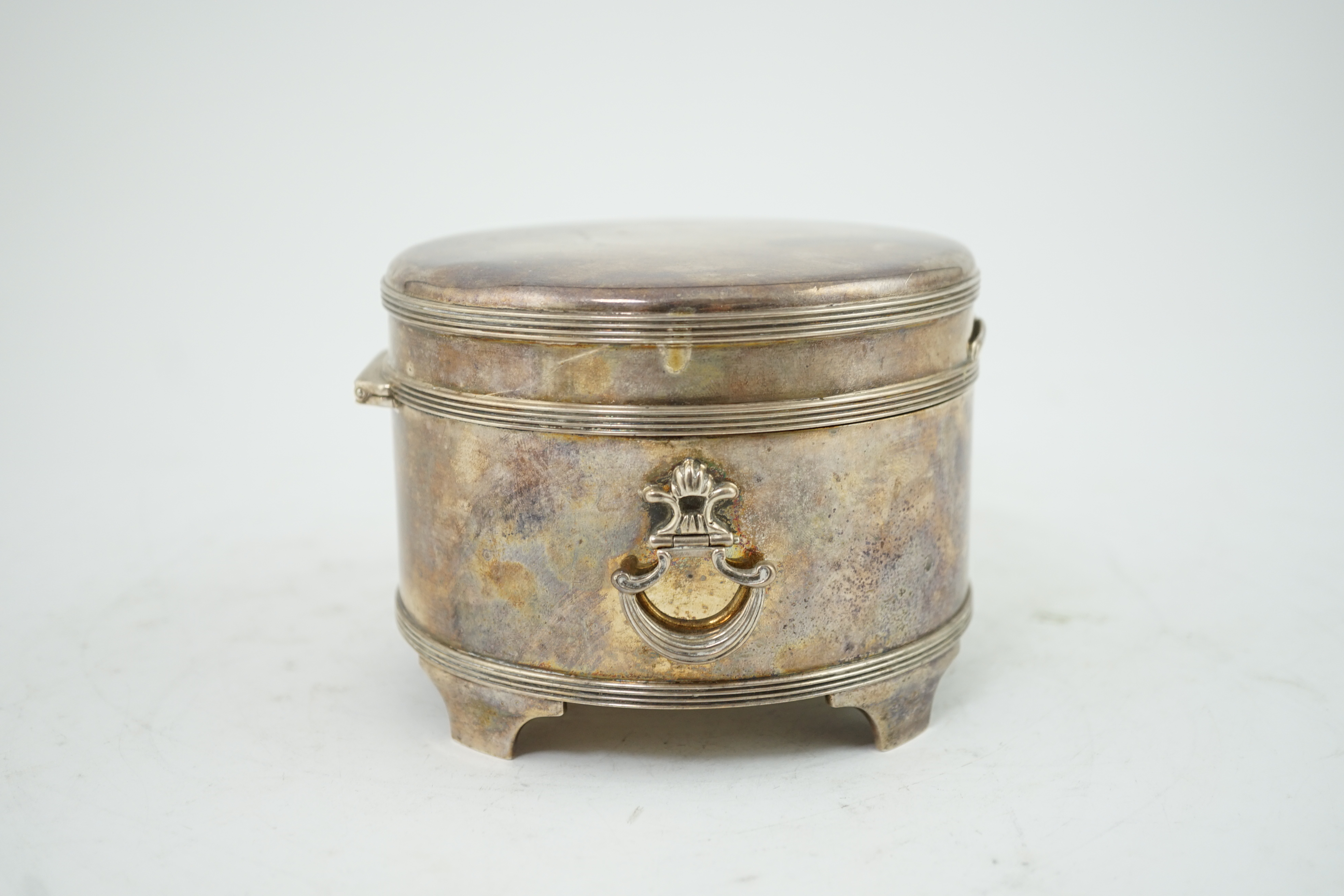 A George V silver circular two handed biscuit box, with hinged cover, by Asprey & Co Ltd